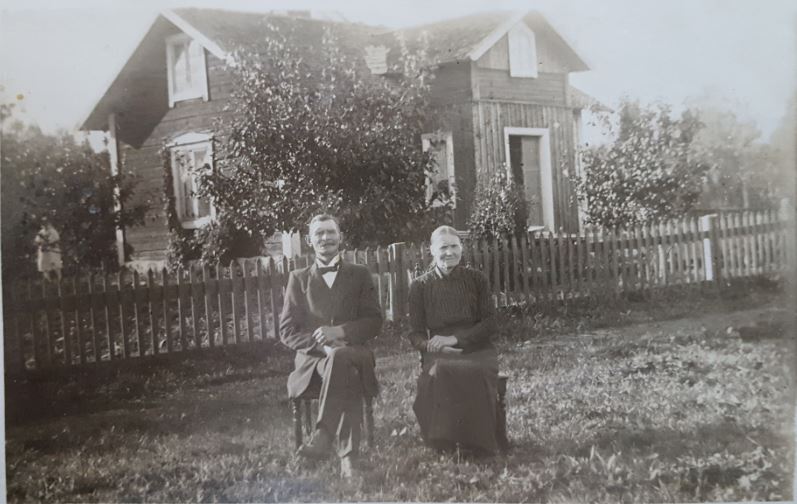 Anders Gustaf Henriksson och fru Emmeli vid sitt hus i Slåttan, Hållnäs